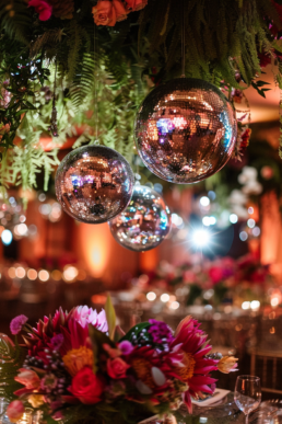 Vibrant banquet with flowers and disco balls, perfect for a festive celebration.