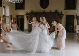 Bridal preparations with joyful bridesmaids in an elegant wedding setting, capturing love and excitement.